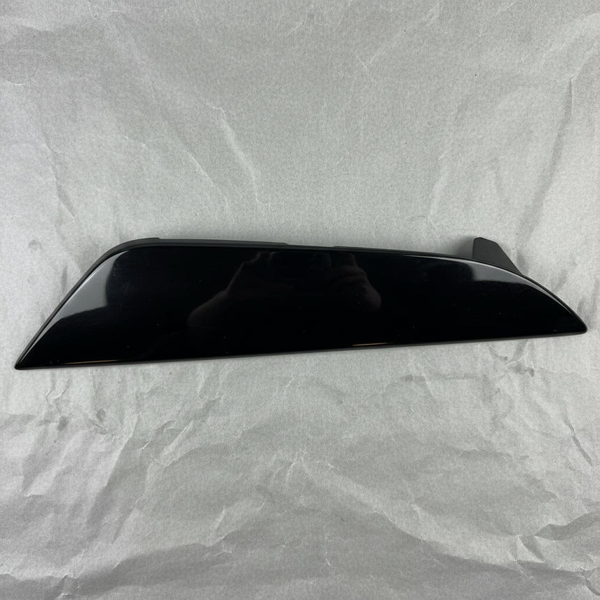 Close-up of Kia OEM Rear Driver Side Bumper Insert Glossy Black for 2021-24 K5