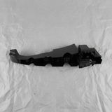 Middle macro crop of Dodge Charger rear bumper fascia support bracket on light grey wrinkled kraft paper