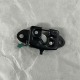 Lower-middle macro crop of rear gate latch on light grey wrinkled kraft paper