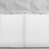 Top macro crop of Mazda CX-9 cabin air filter on light grey wrinkled kraft paper
