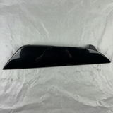 Close-up of Kia OEM Rear Driver Side Bumper Insert Glossy Black for 2021-24 K5
