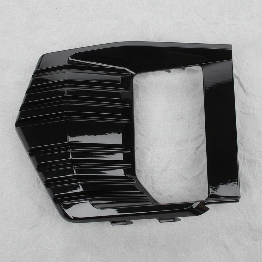 Full view of GMC Yukon fog light lamp bezel trim on light grey wrinkled kraft paper