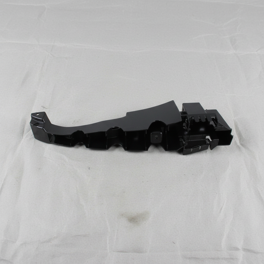 Top macro crop of Dodge Charger rear bumper fascia support bracket on light grey wrinkled kraft paper
