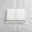 Full view of Mazda CX-9 cabin air filter on light grey wrinkled kraft paper