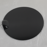 Top macro crop of Ford F-150 fuel tank filler door on light grey wrinkled kraft paper