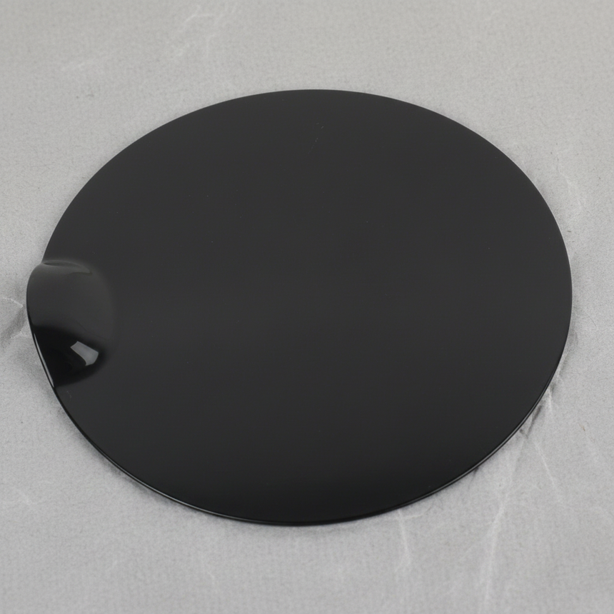 Top macro crop of Ford F-150 fuel tank filler door on light grey wrinkled kraft paper